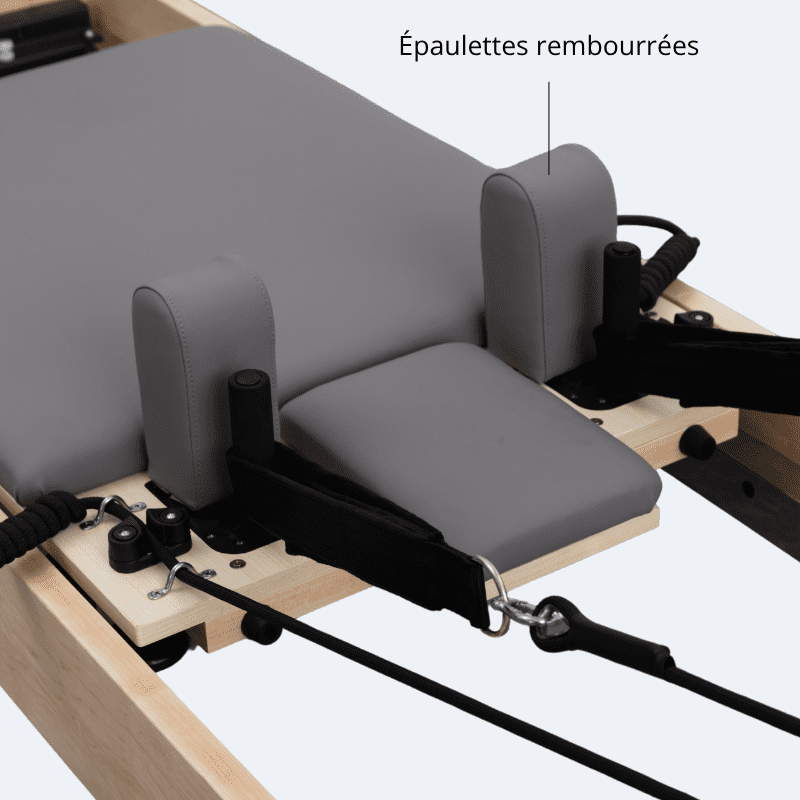 Épaulettes rembourrées tissu gris foncé coutures apparentes plateforme centrale sangles boucles reformer