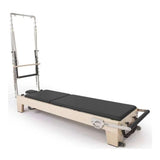 Reformer Pilates Elite en bois d'érable massif avec coussins noirs, vue trois-quarts gauche